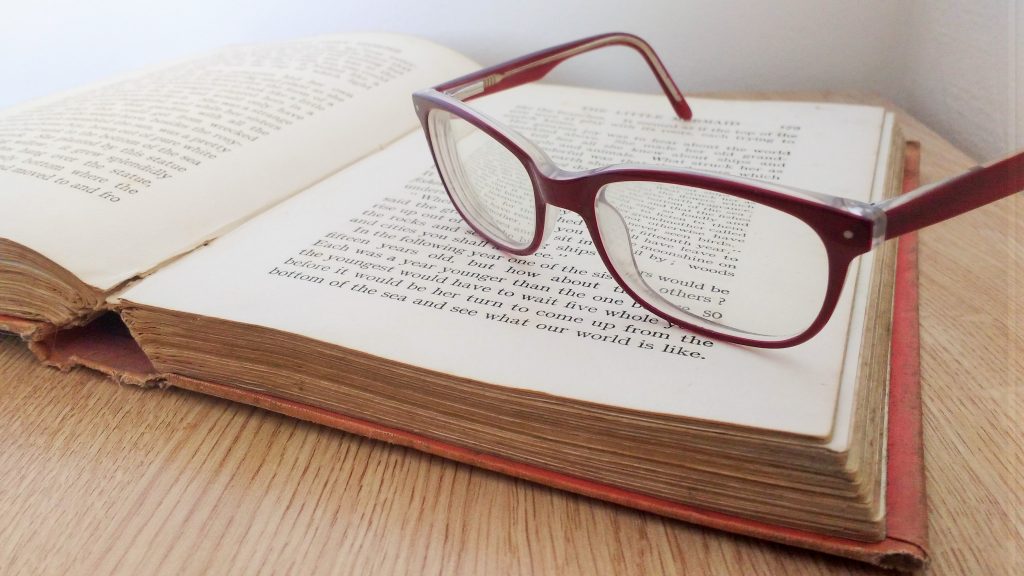 glasses on an old book