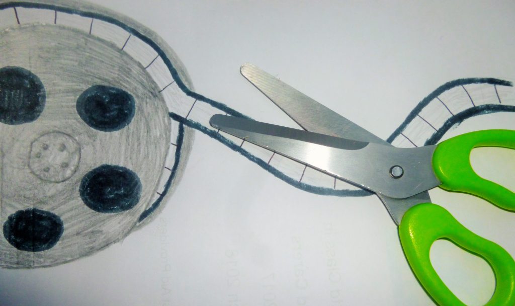 edit film reel green scissors cut