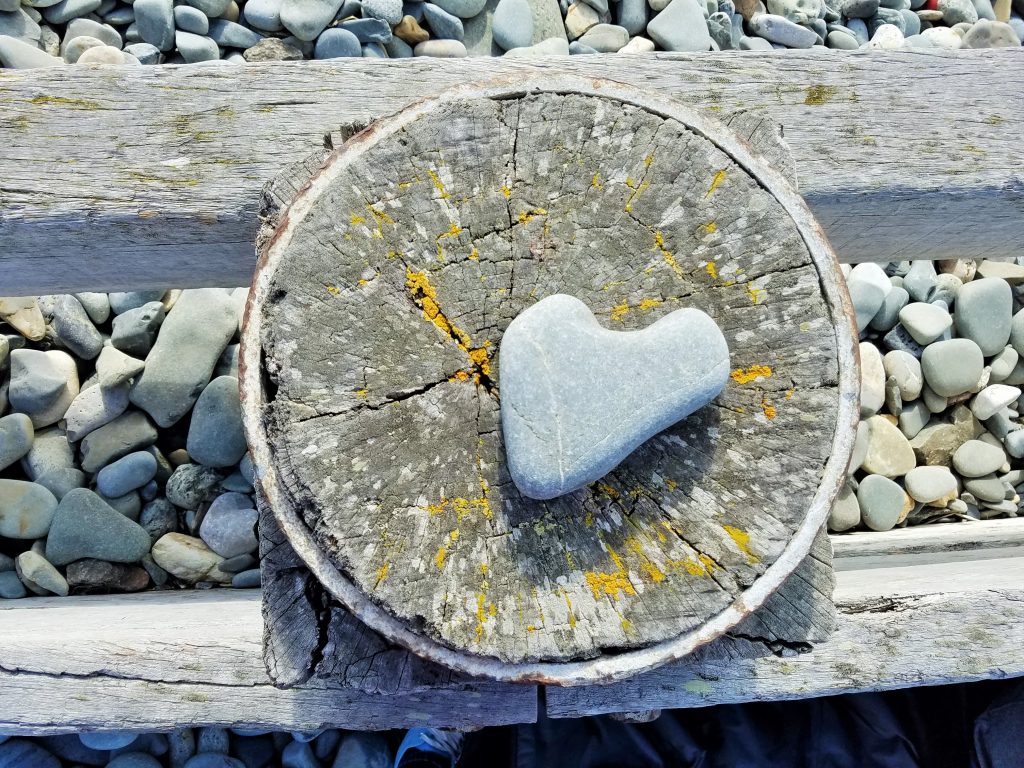 Sensitive heart rock on a wooden circle