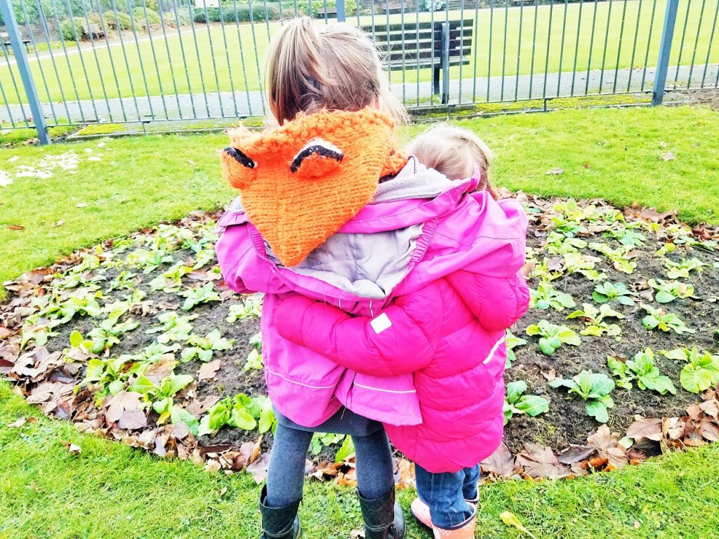 Childhood anxiety - sisters embrace in the park