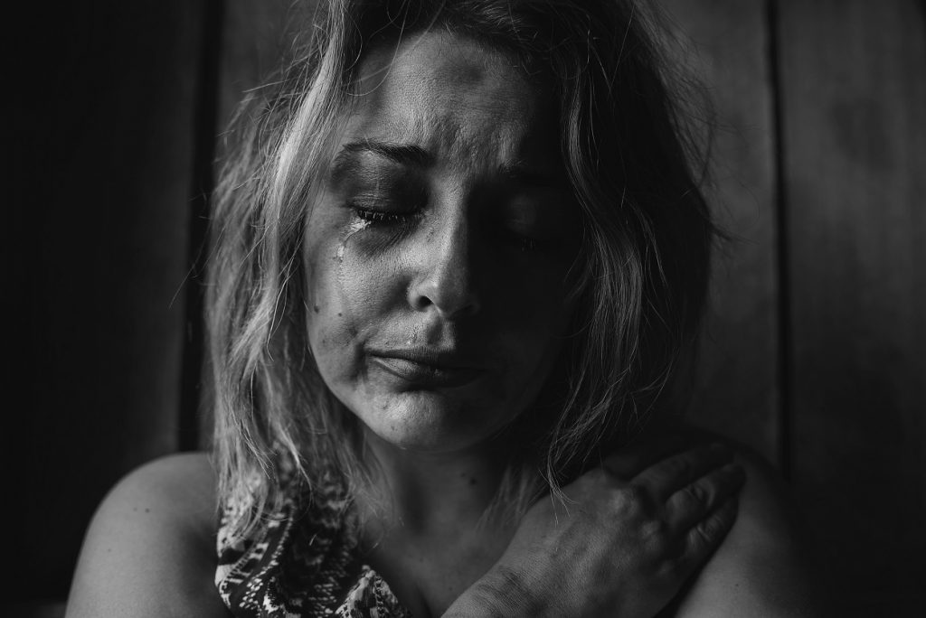 I used to self-harm and it isn't selfish - black and white photo of woman crying