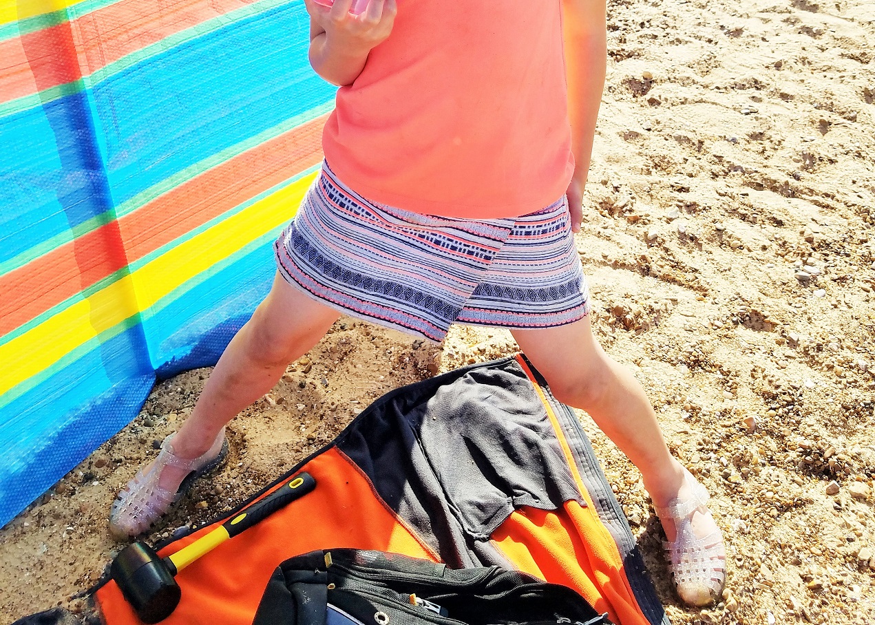 Gentle parenting is not letting your kids run wild - child playing at the beach in bright clothes