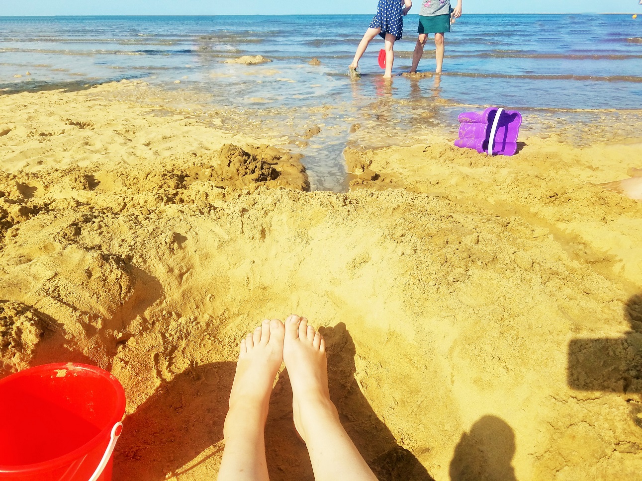 Gentle parenting is not ... - find out what the gentle parenting ethos is - mum watching children playing in the sea