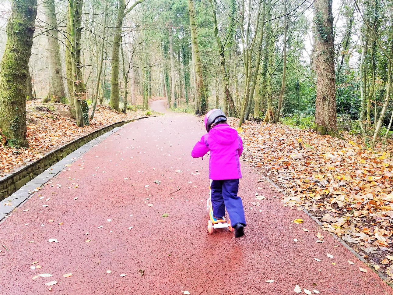 are attachment parenting and gentle parenting the same - child in pink coat on scooter