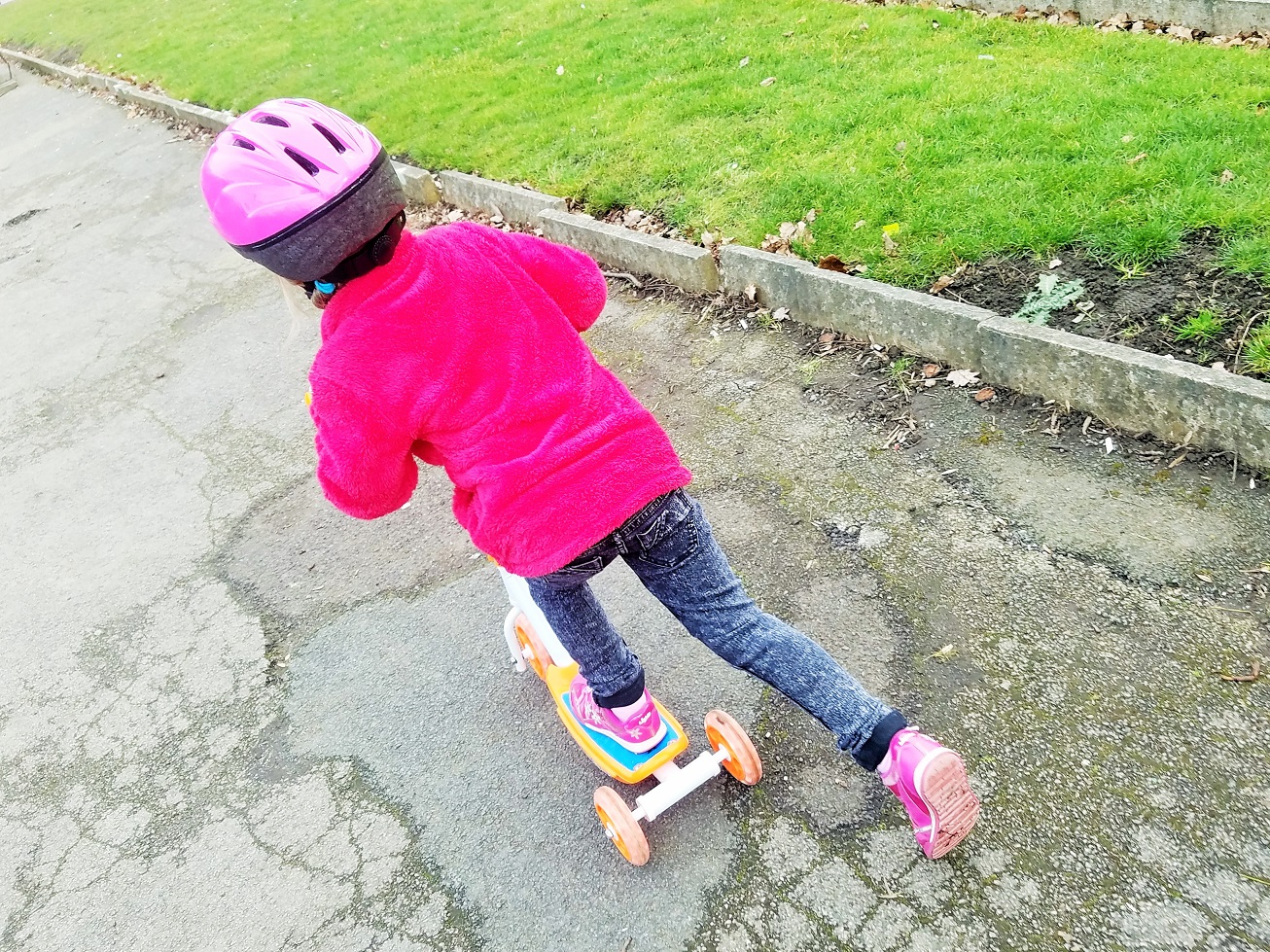 how to discipline as a gentle parent child in red jumper on scooter